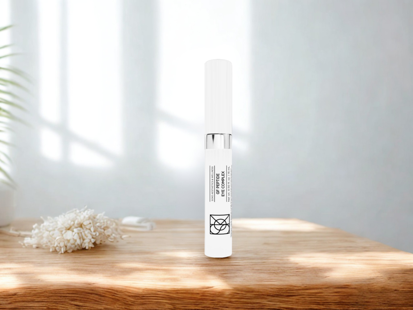 GF Peptide Eye Complex serum bottle on wooden table with natural light, premium Soko growth factor eye treatment for fine lines, puffiness, dark circles, and tech fatigue recovery