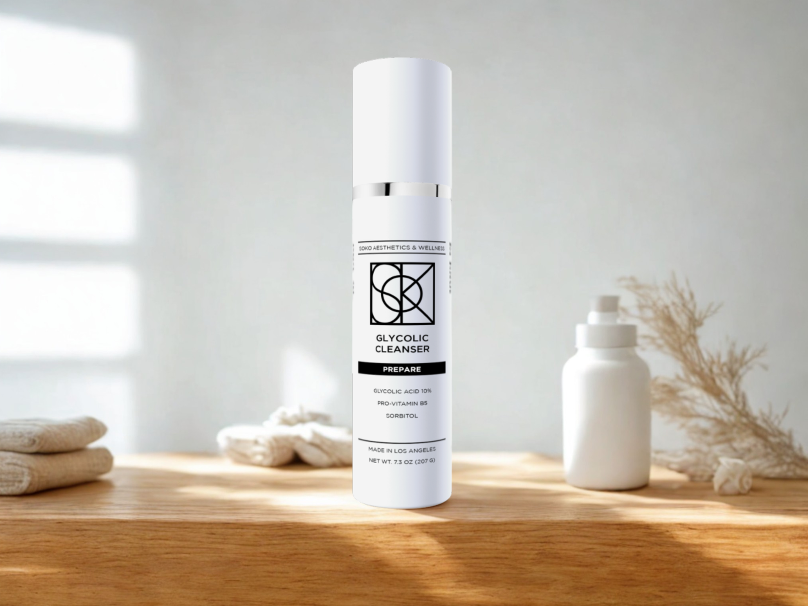 Glycolic Cleanser bottle on wooden table with natural light, premium Soko exfoliating cleanser with 10% glycolic acid and pro-vitamin B5 for radiant, smooth, hydrated skin